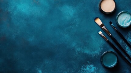A beautifully arranged flat lay of makeup brushes and colorful cosmetics on a vibrant blue background, ideal for beauty blogs, makeup tutorials, or product showcases,
