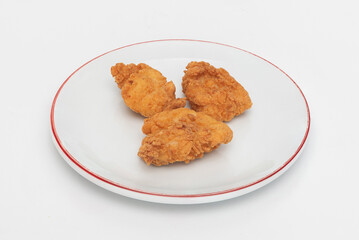 Fried chicken wings on a plate on a white background, close-up