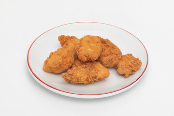 Fried chicken wings on a plate on a white background, close-up