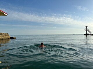 Man is swimming in the ocean