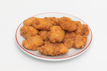 Fried chicken wings on a plate on a white background, close-up