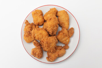 Fried chicken wings on a plate on a white background, close-up