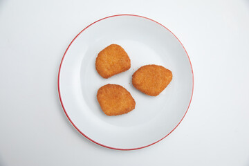 GeneraFried chicken wings on a plate on a white background  close-upted image