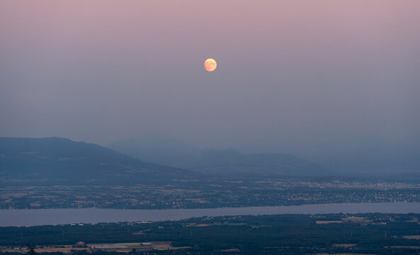 Full moon rising over Lake Leman and Chillon Castle.