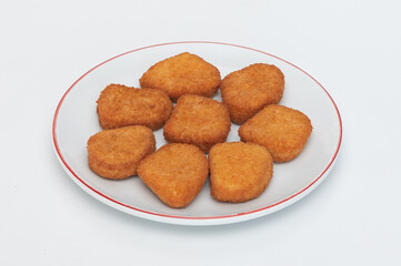 GeneraFried chicken wings on a plate on a white background  close-upted image
