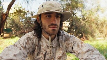 Sad Serviceman Sitting On The Ground In The Countryside Reflects On Memorial Day