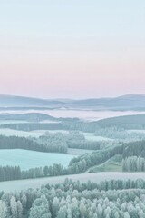 Obraz premium Serene landscape with rolling hills, forests, and misty horizon at dawn