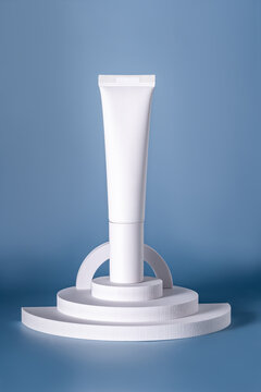Minimalistic white cosmetic tube on circular podium