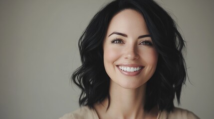 Happy woman in beige top with short hair.