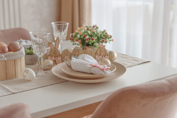 Festive Easter table setting with Easter bunny made from napkin. Easter celebration concept