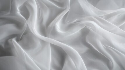 Obraz premium Close-up of a white fabric with a smooth and elegant texture. the fabric appears to be made of a silky or satin-like material, with a subtle sheen that catches the light.