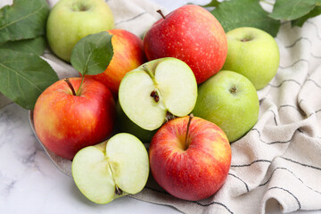 Different ripe apples on white table, closeup