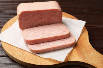 Tasty canned meat on wooden table, closeup