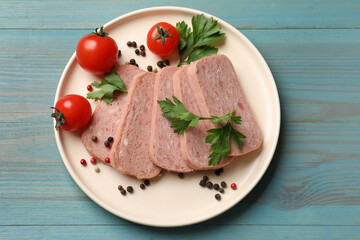 Pieces of tasty canned meat, parsley, peppercorns and tomatoes on light blue wooden table, top view