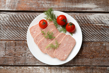 Tasty canned meat, tomatoes and dill on wooden table, top view