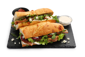 Halves of baguette sandwich with prosciutto and sun dried tomatoes isolated on white