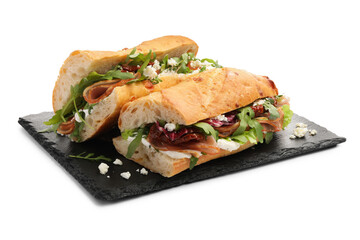 Halves of baguette sandwich with prosciutto and sun dried tomatoes isolated on white