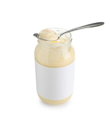 Tasty mayonnaise sauce in glass jar with blank label and spoon isolated on white
