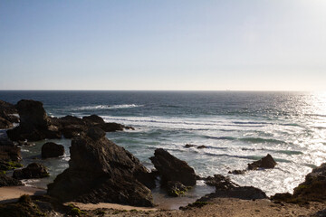 Stunning view of dramatic cliffs and the vast ocean in Porto Covo, Portugal, showcasing the power of nature and the serene beauty of the coastline