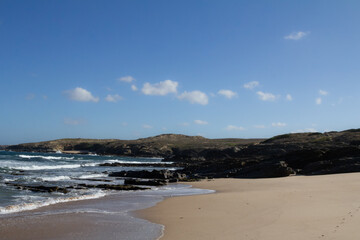 The ocean waves along the Rota Vicentina trail are perfect for surfing, with powerful swells crashing onto the shore. This popular coastal route provides an ideal setting for surfers