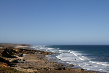 The ocean waves along the Rota Vicentina trail are perfect for surfing, with powerful swells crashing onto the shore. This popular coastal route provides an ideal setting for surfers