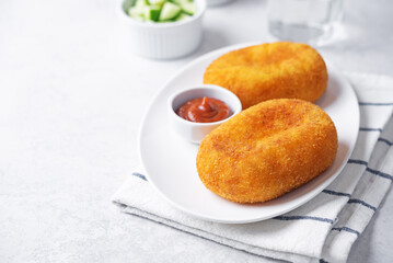 Asian potato cakes with filling, croquet, korokke with tomato sauce in a plate