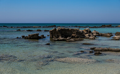 single stones on the sandy coast of the Mediterranean Sea on the island of Crete