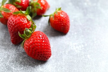 Delicious fresh red strawberries on a gray background