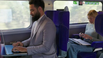 On a modern train, African American businessman and a skilled woman are collaborating effectively, exemplifying productivity and the advantages of contemporary commuting in todays fastpaced world