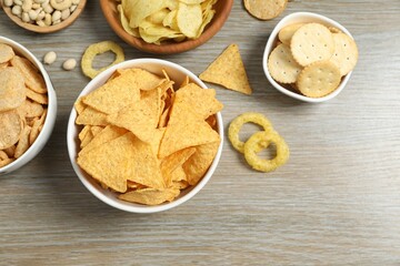Various unhealthy snacks on wooden background