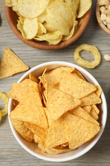 Various unhealthy snacks on wooden background