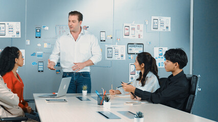 Group of professional business people discuss about using Ux and Ui design. Cooperative diverse business team brainstorming about marketing plan. Business people working together. Manipulator.