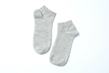 Gray socks on white background, flat lay. Space for text