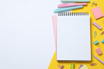 Flat lay with stationery and notebook on color background, top view