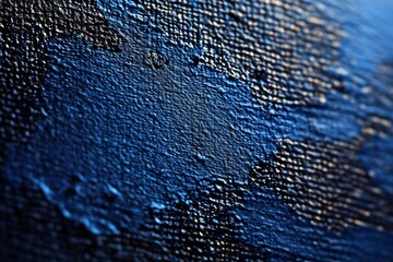 Close-up view of textured blue paint on a canvas showcasing vibrant strokes and intricate details