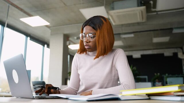 African American student preparing for exam with laptop