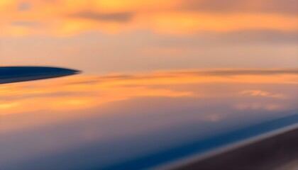 Fototapeta premium a view of the wing of an airplane at sunset