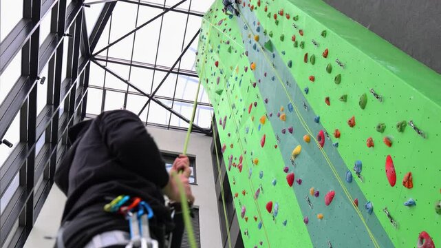 Two people on a climbing wall, partners, trust, sport, extreme sports. Slow motion video.