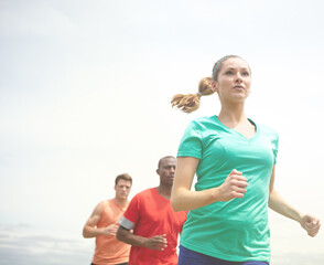 People, fitness or running with sky for workout, exercise or physical activity in nature together....