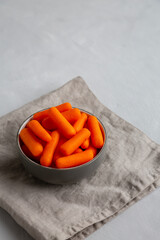 Organic Baby Carrots in a Bowl, side view. Copy space.