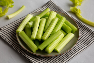 Raw Organic Celery Sticks on a Plate, side view.