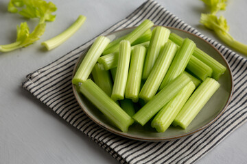 Raw Organic Celery Sticks on a Plate, side view.