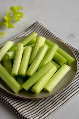 Raw Organic Celery Sticks on a Plate, side view.