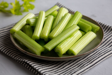 Raw Organic Celery Sticks on a Plate, side view.