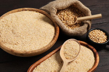 Oat bran and grains on wooden table, closeup