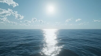 Obraz premium Sunlit ocean surface with blue water and bright sun.