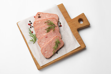 Pieces of tasty canned meat, dill and peppercorns on white background, top view