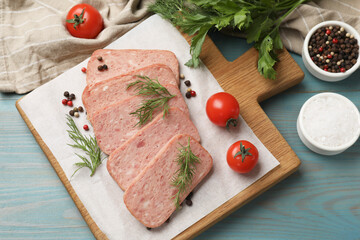 Pieces of tasty canned meat, dill, spices and tomatoes on light blue wooden table, flat lay