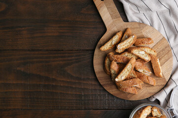 Traditional Italian almond biscuits (Cantucci) on wooden table, top view. Space for text