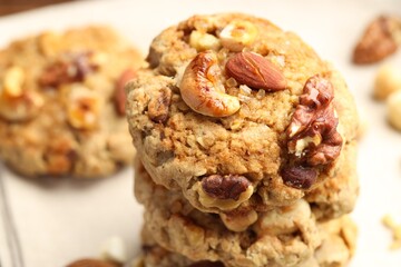Tasty cookies with nuts on light table, closeup